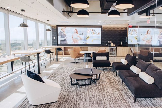 Large office space with natural light and many couches and chairs for sitting.