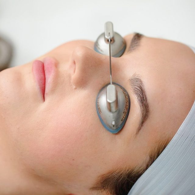 Light skinned woman with covers over her eyes.