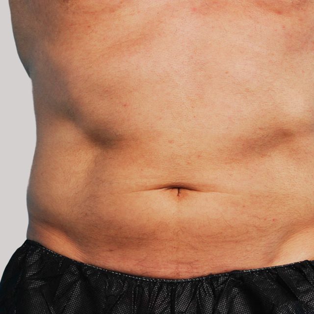 Closeup of a male's stomach and abdomen region.