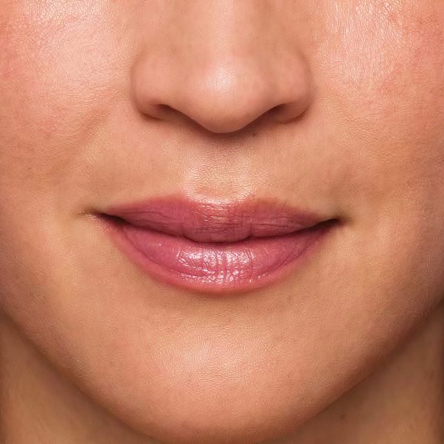 Closeup of a woman's nose and lip area.