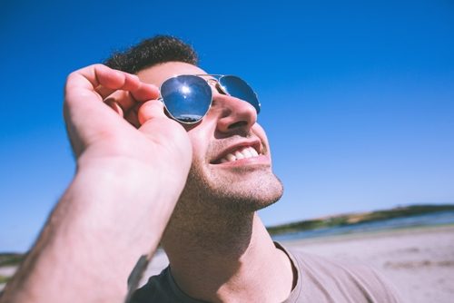 Adult male with aviator sunglasses looking at the sky