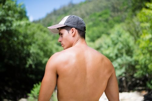 Male shirtless wearing a baseball cap.