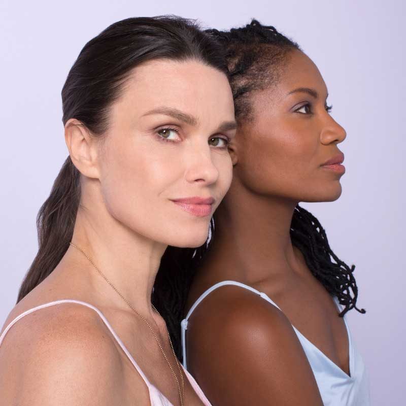 Headshot of two woman with differing skin types.