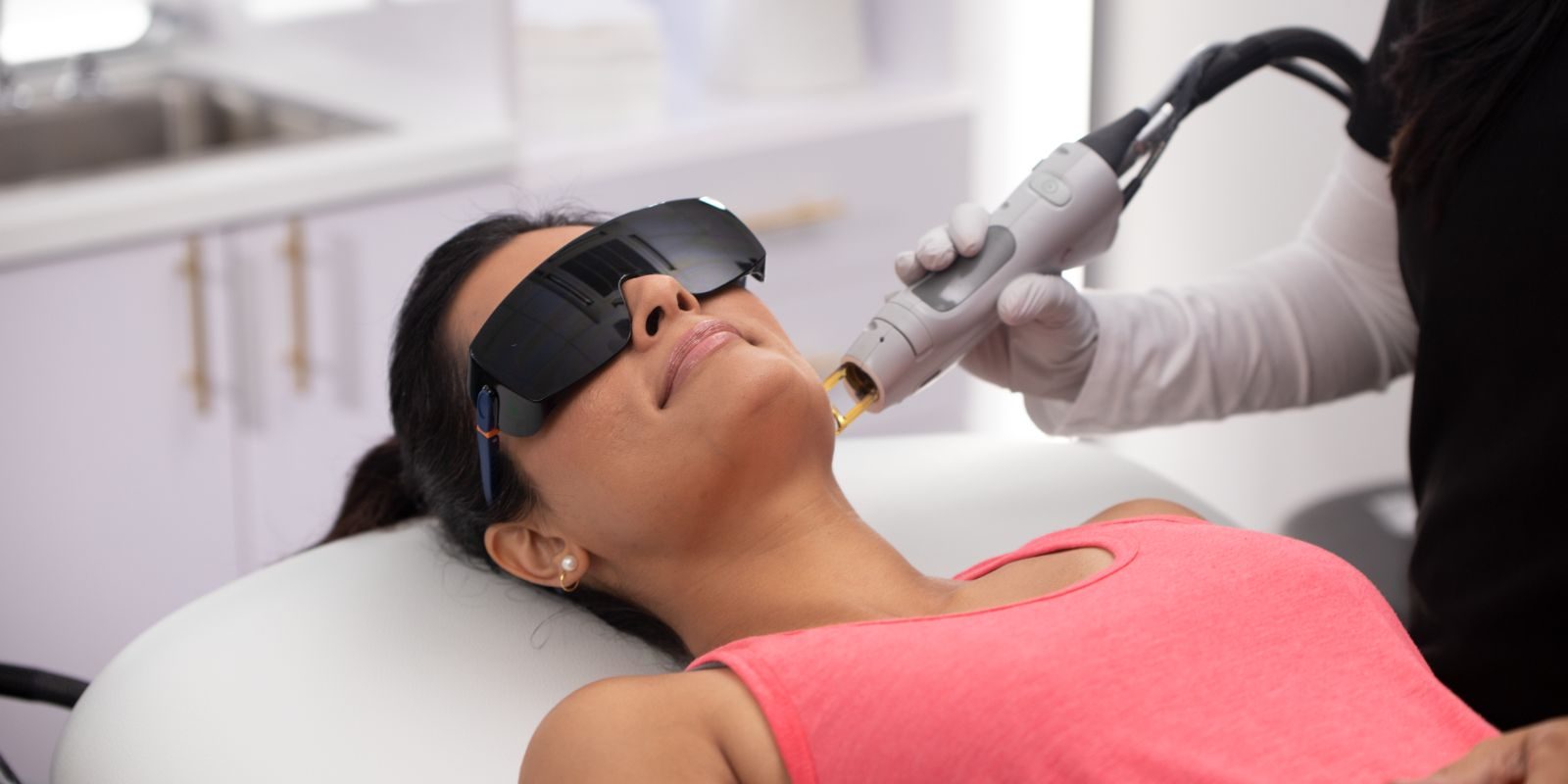 woman receiving laser hair removal on face