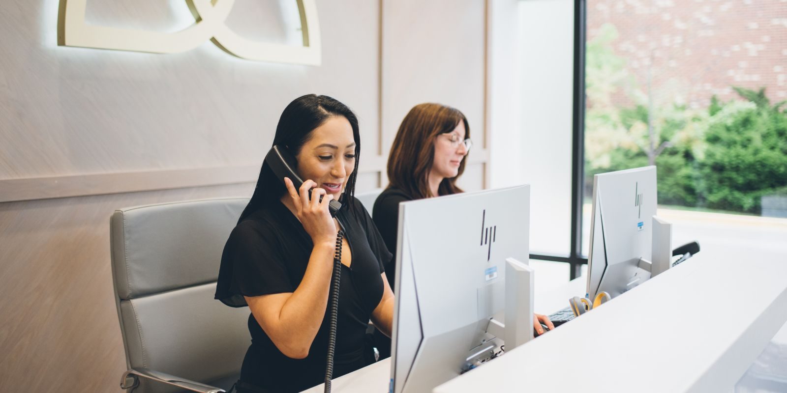two women at a reception desk