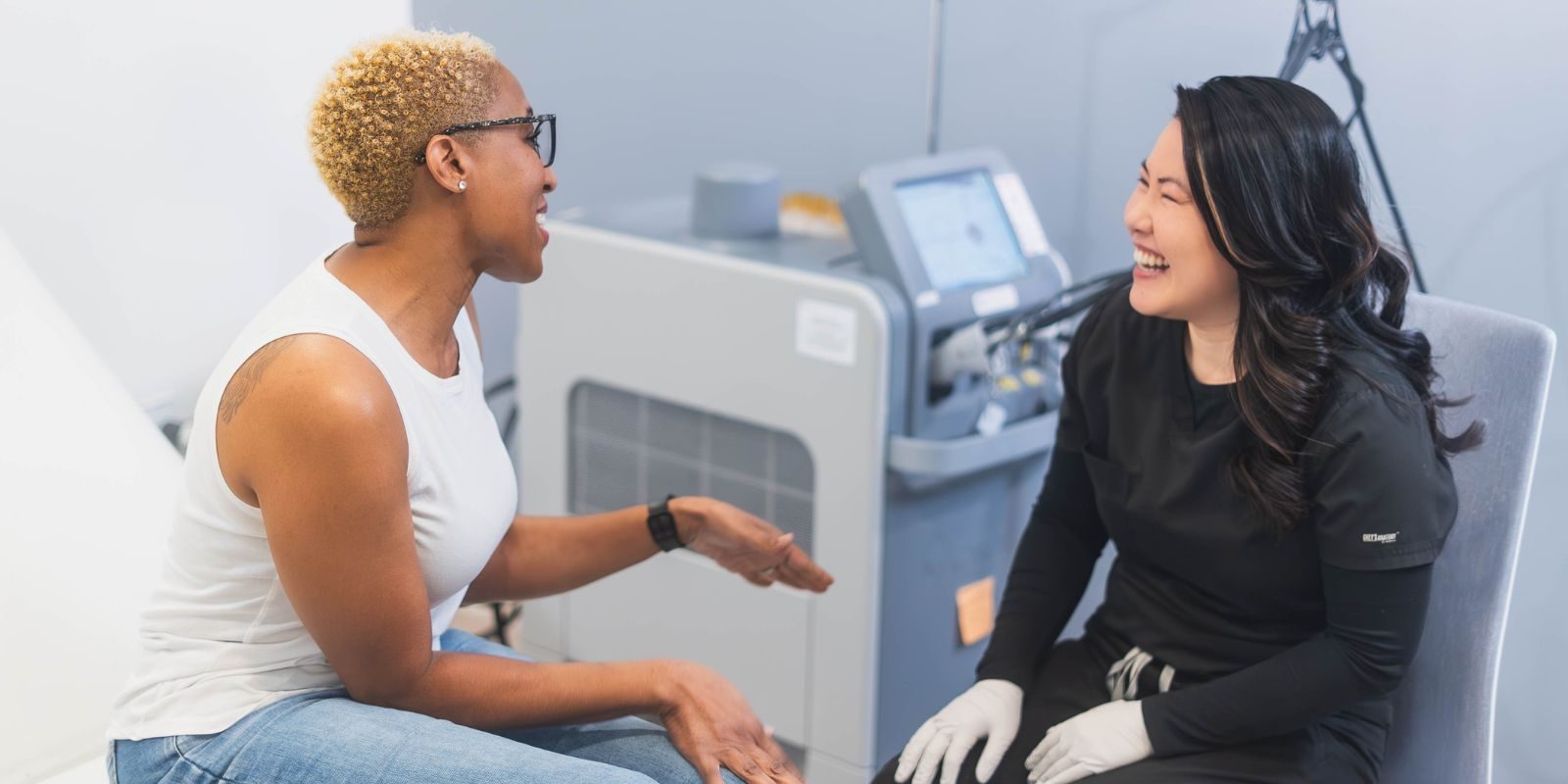 Two women sitting in an exam room.