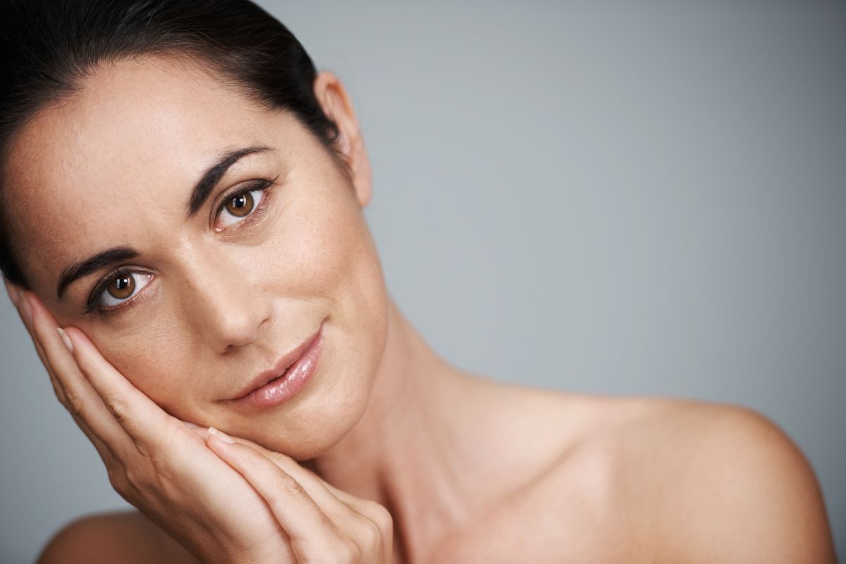 Woman resting face in hands.