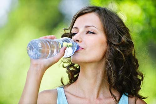young woman drinking water from a bottle