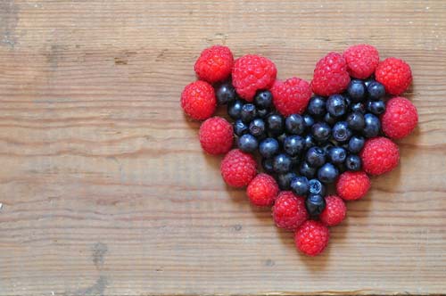 raspberries and blueberries in shape of a heart