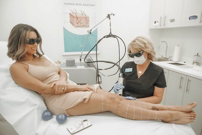 woman receiving laser hair removal on legs