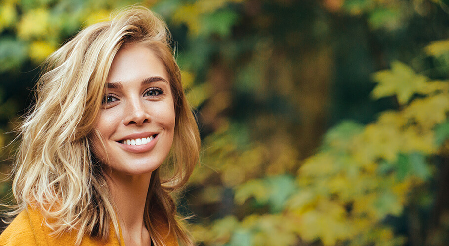 young woman outdoors smiling